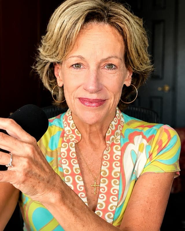 Marybeth Wuenschel, founder and president of Where 2 or More Gather Ministries, speaking into a microphone